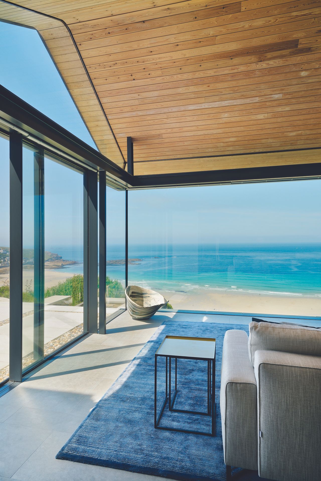 modern licing room in glass extension with view over sea
