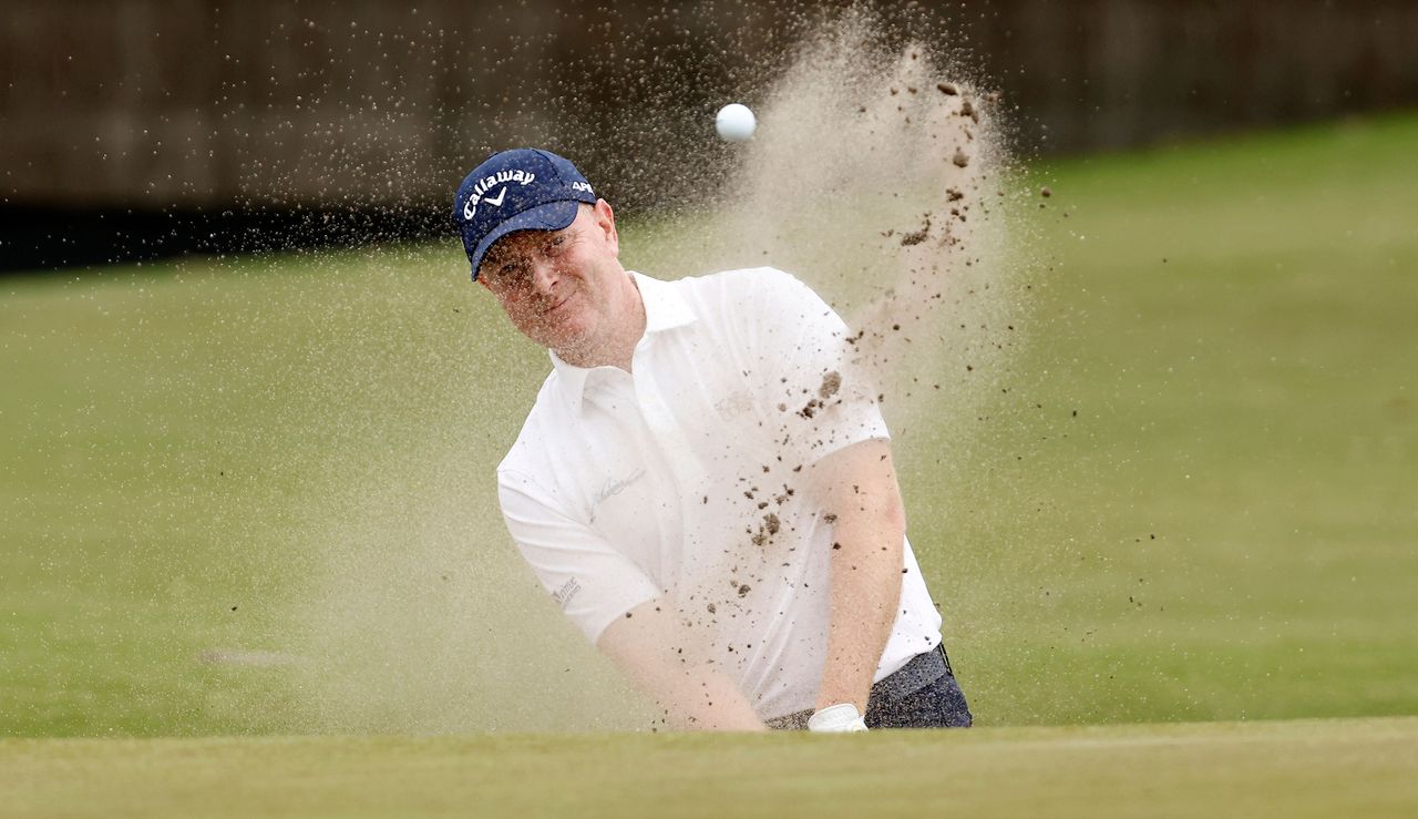 Richard McEvoy hits a bunker shot 