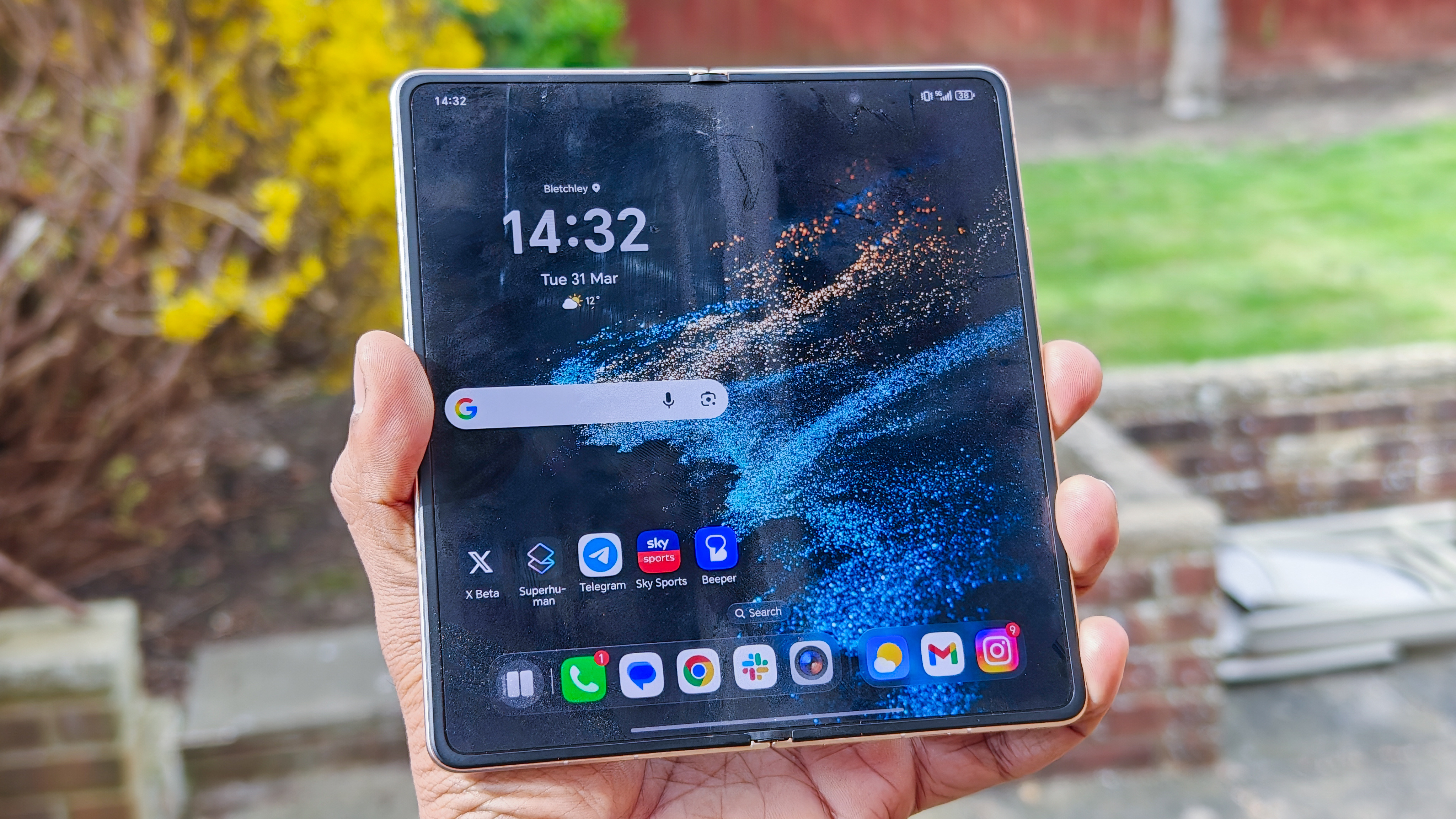 The Honor Magic V6 in gold after being put through a washing machine, complete with scratches and blemishes but fully working.