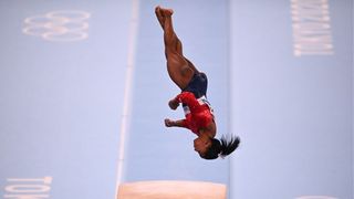 simone biles mid-twist during a vault at the Tokyo Olympics