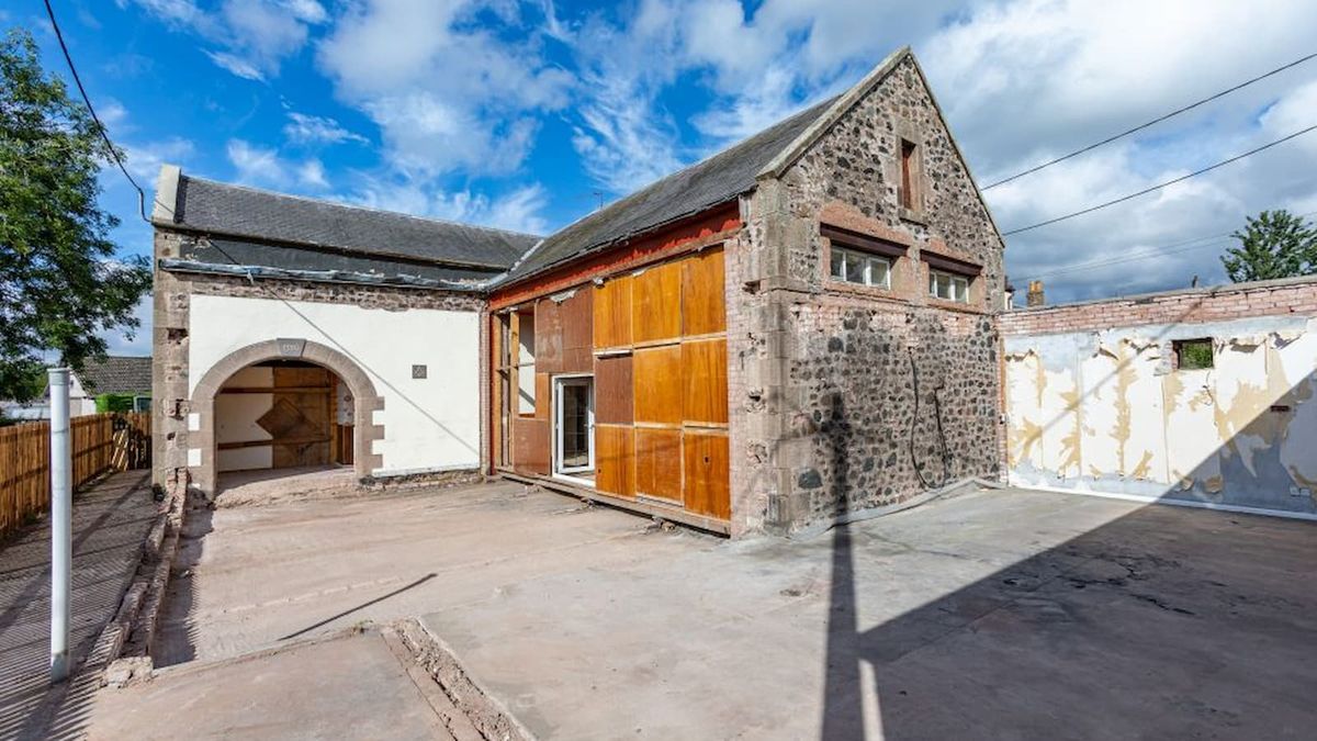 A stone home with original archway entrance