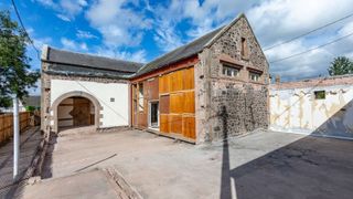 A stone home with original archway entrance