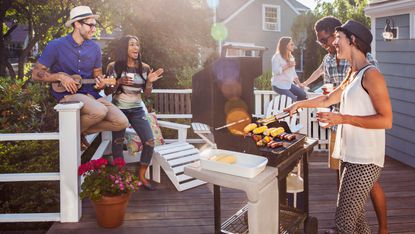 how to light a bbq: party with friends in garden