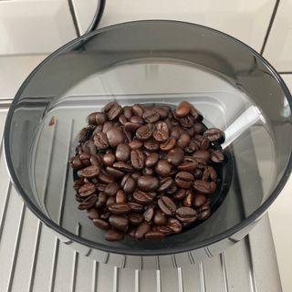 Coffee beans in the container of the coffee grinder on the Ariete 1313 espresso maker