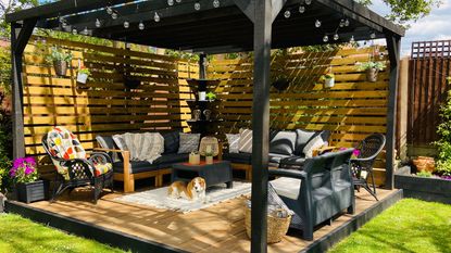 finished DIY pergola in garden with outdoor furniture
