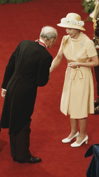 Queen Elizabeth II carries out an investiture ceremony in Wellington during her tour of New Zealand, 1977.