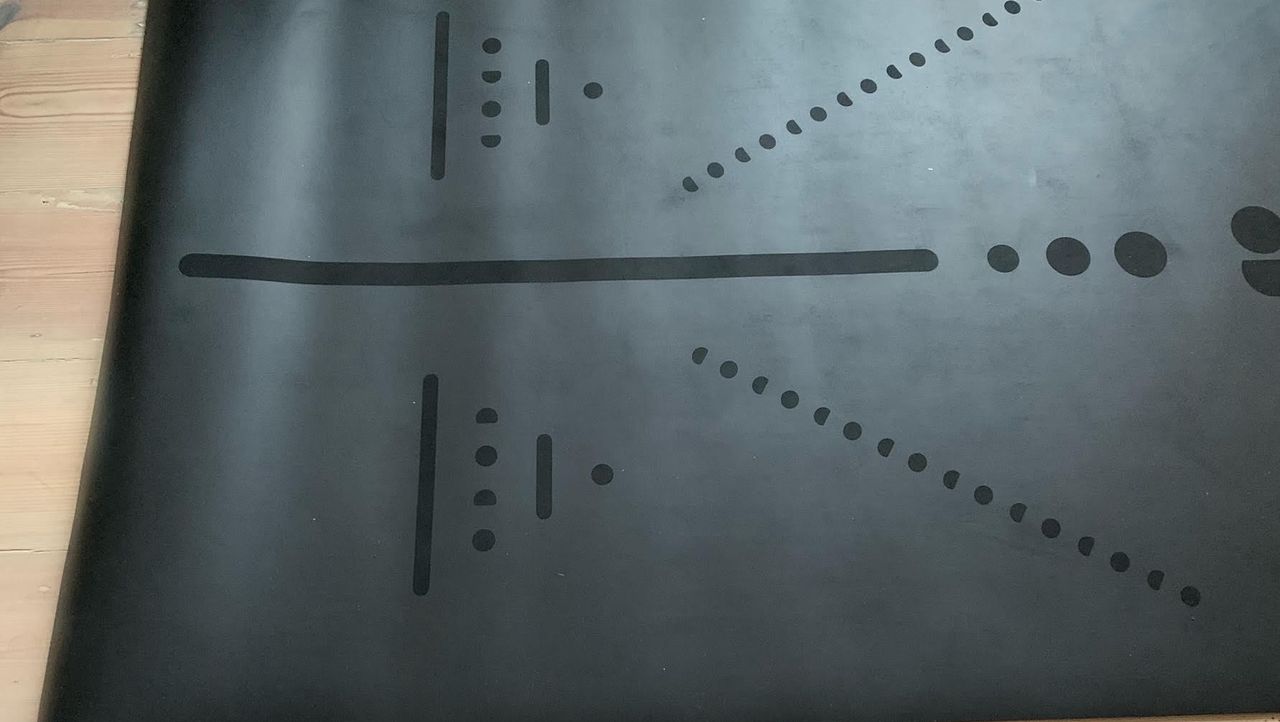 Lululemon workout mat rolled out on a clean wooden floor
