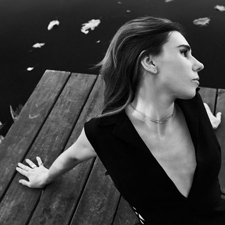 zosia mamet sitting on a dock
