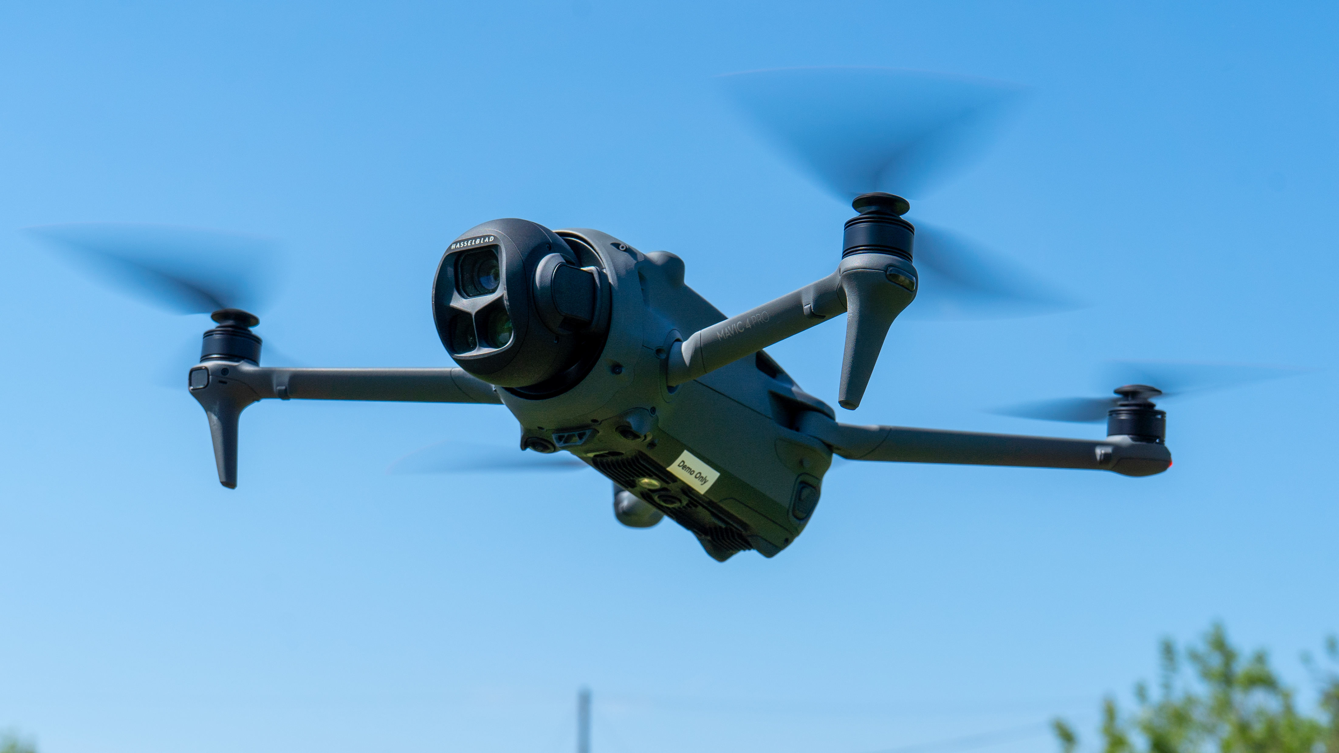 DJI Mavic 4 Pro drone flying against a blue sky