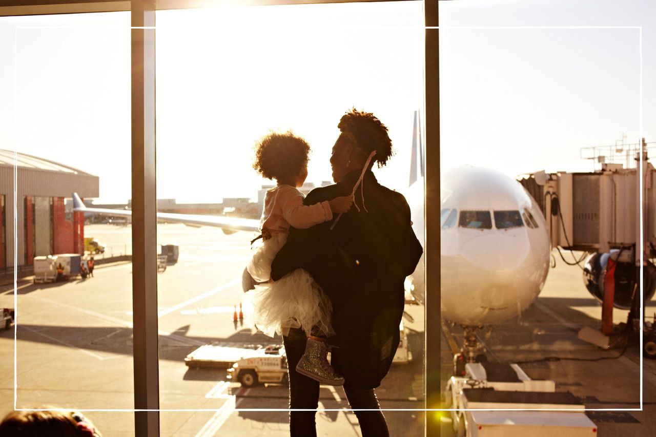 Mother holding daughter at airport