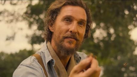 Matthew McConaughey holding a bee while others swarm around him in The Rivals of Amziah King. 