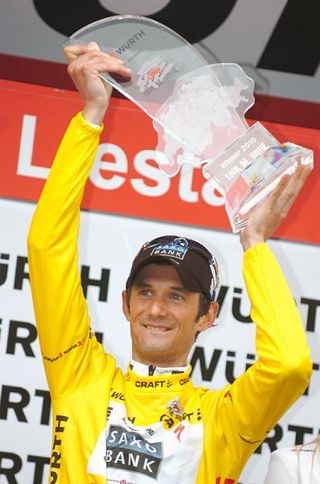 Fränk Schleck (Saxo Bank) hoists aloft the trophy for his overall Tour de Suisse victory.