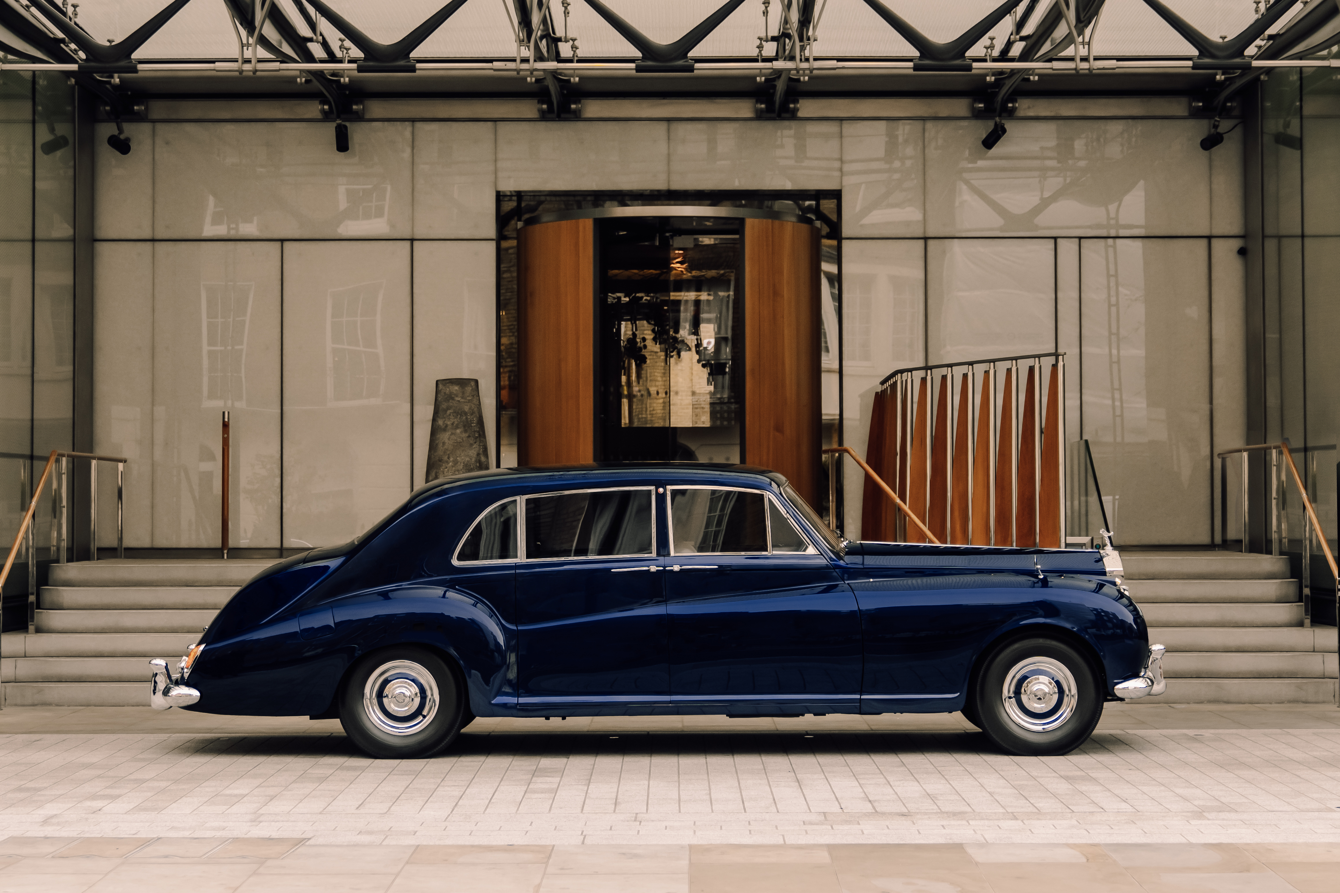A side profile of the Lunaz Phantom V in front of a London hotel