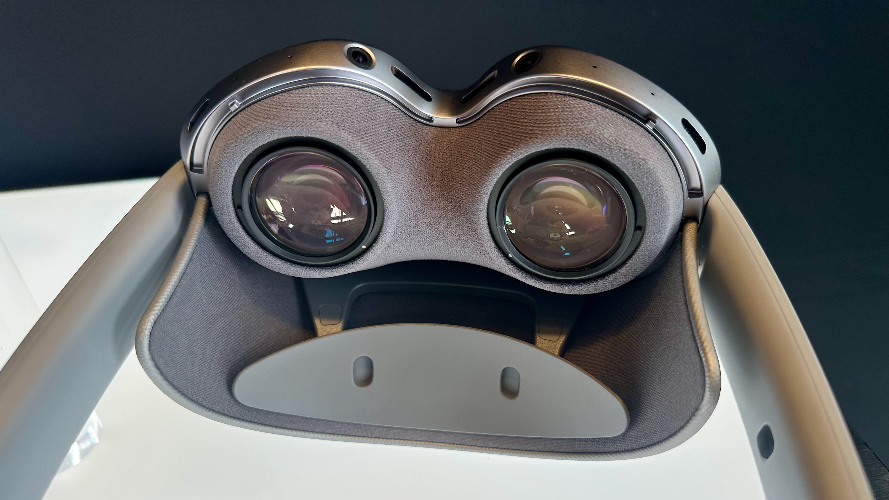 A photo of the Samsung Galaxy XR headset sitting upside down, emphasizing the lenses and forehead padding. 