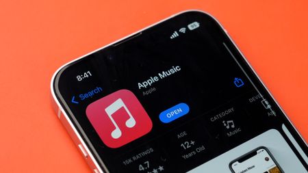 Apple Music in the iPhone app store on an orange background