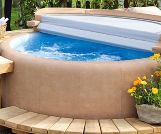 An inflatable hot tub with a cover and deck