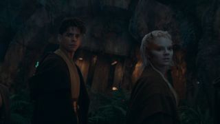 Yord and Jecki look at something behind them in a cave in Star Wars: The Acolyte