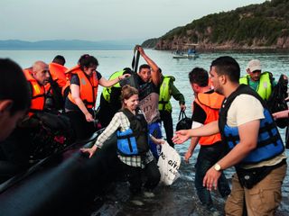 Refugees getting off boats