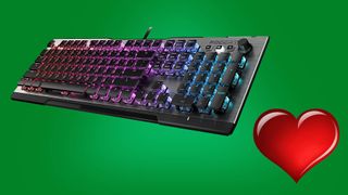 gaming mechanical keyboard and red heart against green background