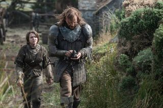 Arya Stark and "The Hound" modeling an armored tunic in "Game of Thrones."