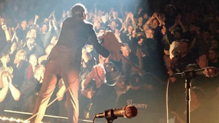 A picture showing Joe Bonamassa hitting bouncer on the head with his guitar