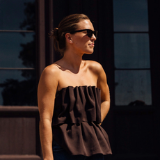 woman wearing a brown tube top and a pair of blue jeans in Copenhagen
