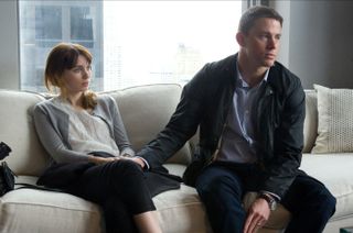 Emily Taylor (Rooney Mara) and Martin Taylor (Channing Tatum) sit on a couch holding hands in Side Effects