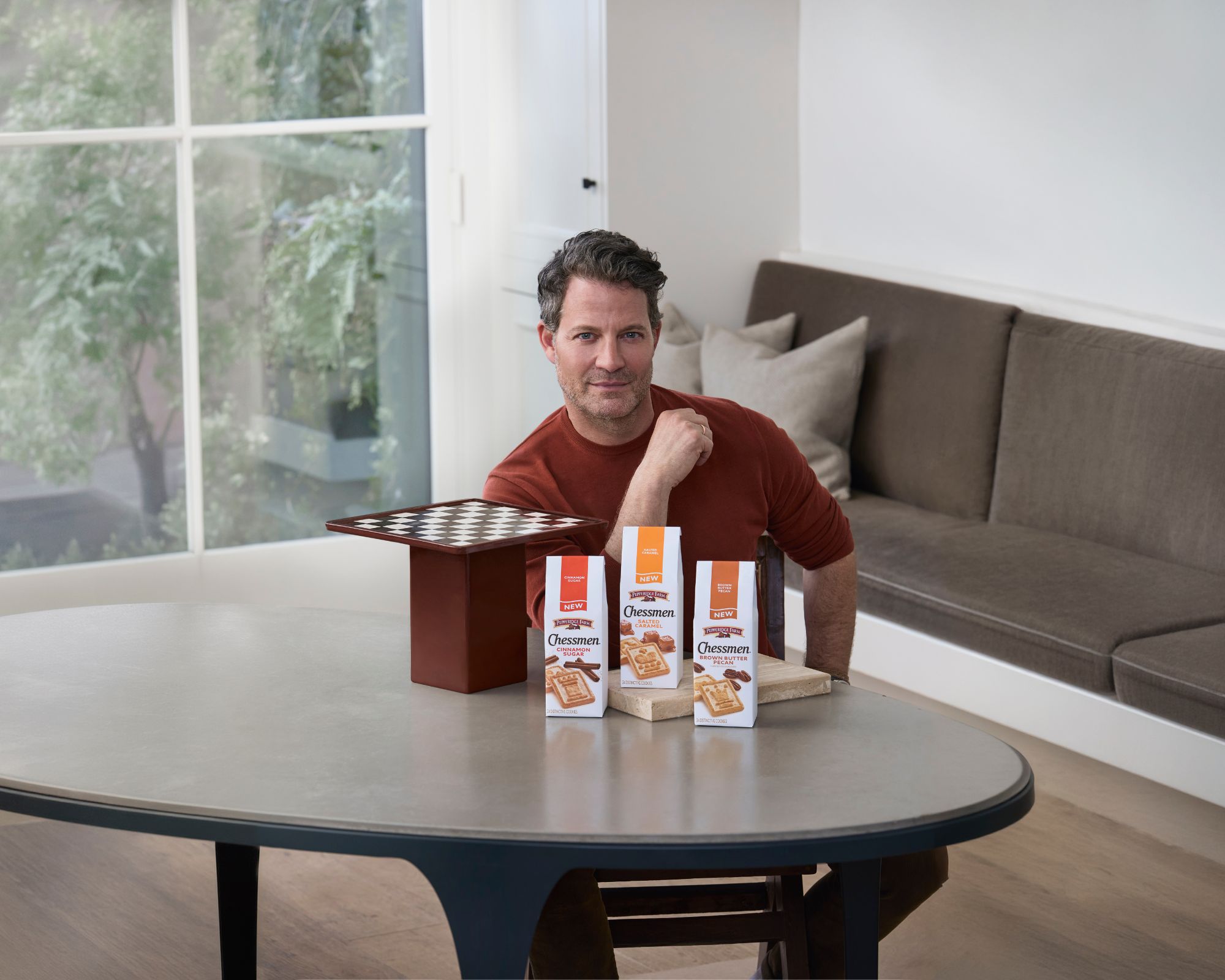 nate berkus with his pepperidge farm chessman board