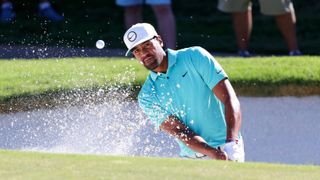 Tony Finau of the United States plays a shot from a bunker on the 16th hole during the first round of the Charles Schwab Challenge 