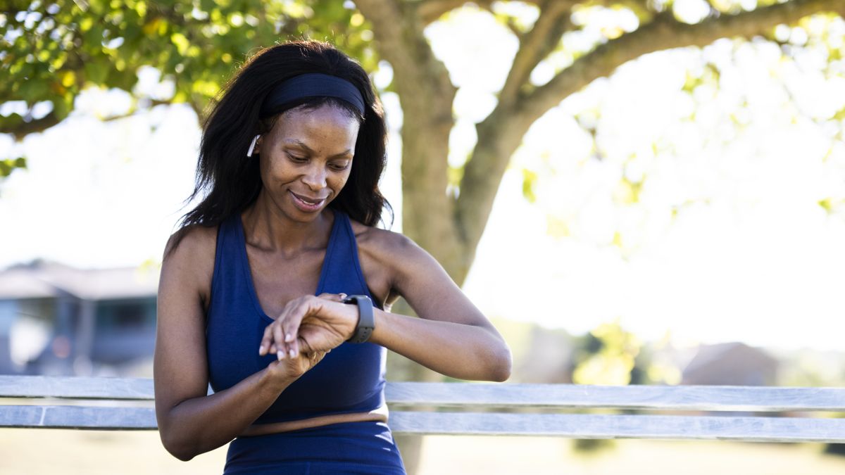 Woman checking her sports watch during workout