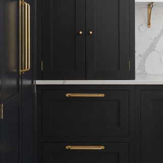 Black kitchen with brass bar handles