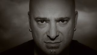 A screenshot of the Disturbed Sound Of Silence video, showing singer David Draiman staring at the viewer