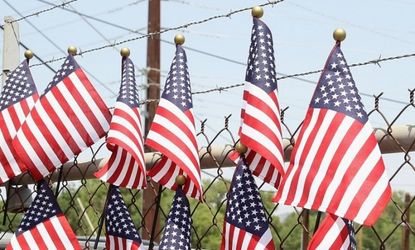 American flags hang on the fence at a memorial outside of Station 7 on in Prescott, Arizona, where 19 firefighters died battling a fast-moving wildfire near Yarnell, AZ on June 29.