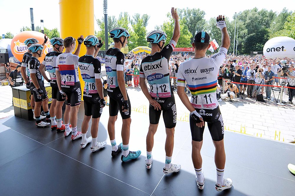 World champion Michal Kwiatkowski and his Etixx-QuickStep team wave to the fans