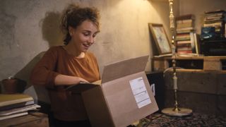 Woman surprised when opening box