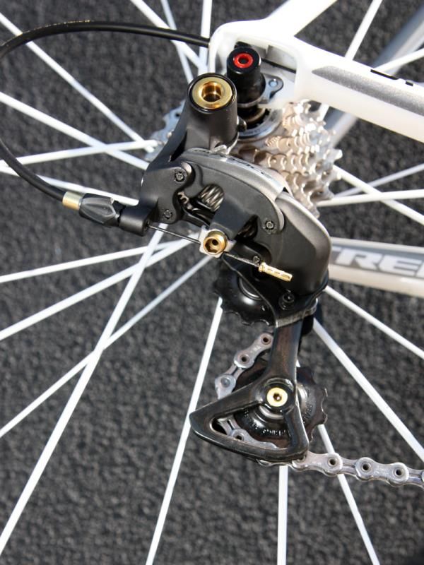 The main pivot bolt, cable anchor bolt, pulley bolts, housing end cap, and even the cable end cap are all gold on Fabian Cancellara's (Leopard Trek) Trek Madone. Check out how the cable anchor bolt is drilled out, too.