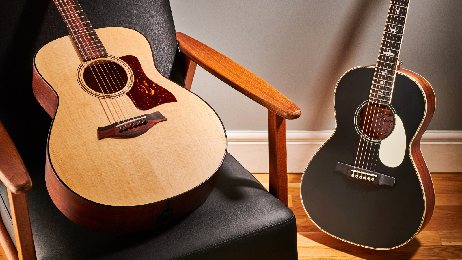 Taylor and PRS acoustic guitars in a living room