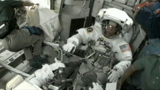 Astronaut Mike Fossum suits up for spacewalk