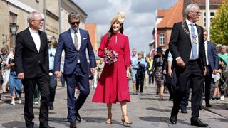 Crown Prince Frederik and Crown Princess Mary with Mayor Knud Erik Langhoff and Priest Joergen Boeytler walk past wellwishers as they attend celebrations of Christiansfeld's 250th anniversary