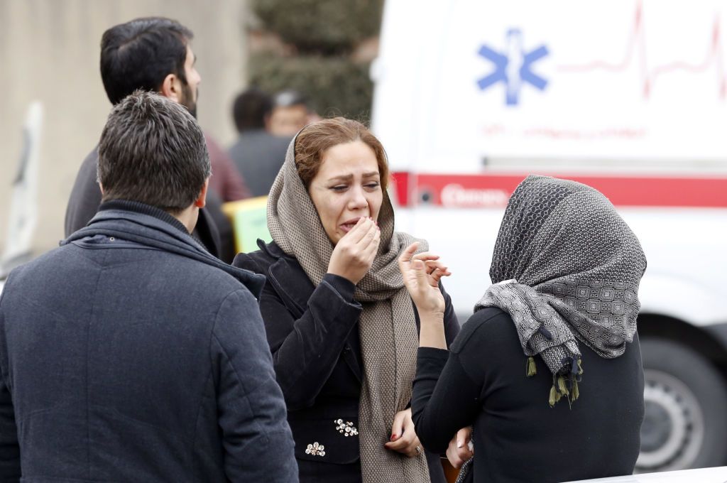 Relatives of Iranian passengers, onboard the Aseman Airlines flight EP3704, react as they gather in front of a mosque near Tehran&amp;#039;s Mehrabad airport on February 18, 2018.