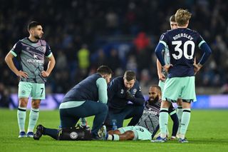 Is Brentford star Bryan Mbeumo injured this weekend? Bryan Mbeumo of Brentford is injured during the Premier League match between Brighton & Hove Albion and Brentford FC at American Express Community Stadium on December 06, 2023 in Brighton, England.