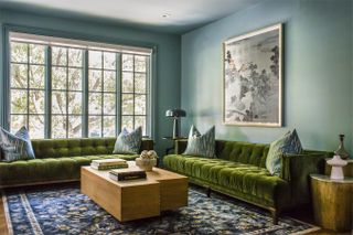 a blue living room with a green sofa