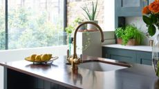 Clean, slick kitchen counter with a pedestal stand