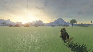 The Legend of Zelda: Tears of the Kingdom screenshot of Link riding a horse across a vast field.