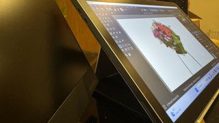 A Huion Kamvas Studio 16 drawing tablet in use on a table