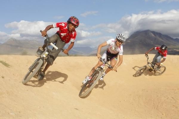 Christoph Sauser zips around a track with his younger friends