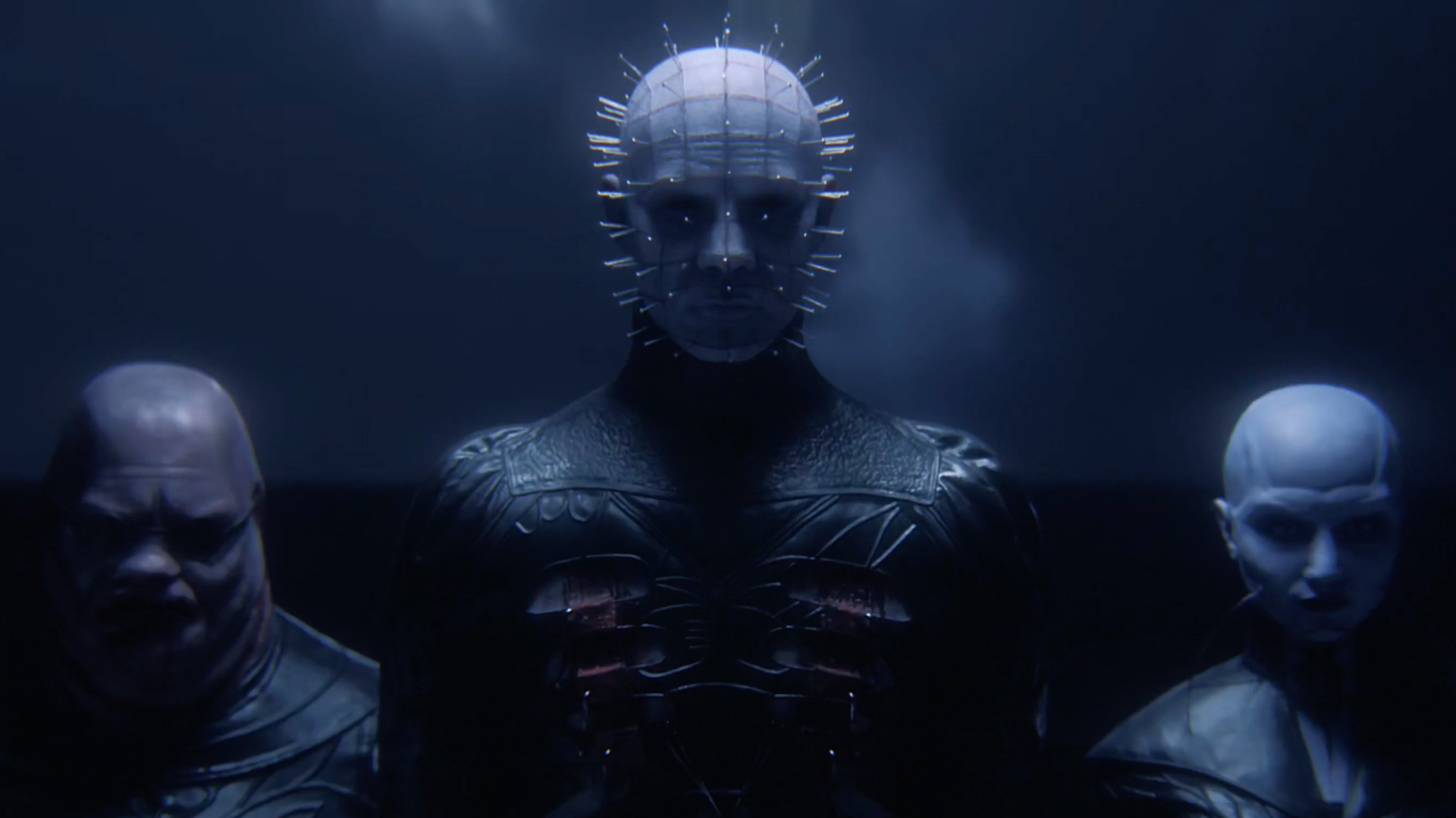 Pinhead stands with two Cenobites