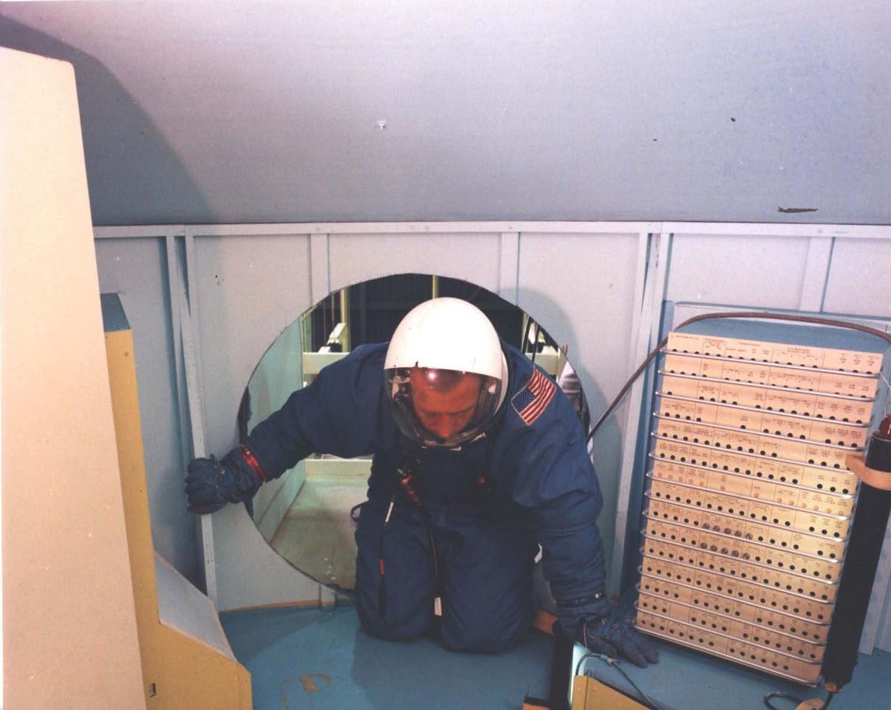 Entering the mockup of the MOL laboratory module. The laboratory would serve as a manned orbiting reconnaissance platform for the top-secret National Reconnaissance Office (NRO).