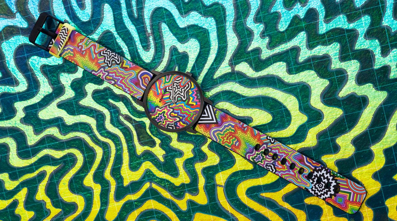 Brightly coloured watch on a patterned background