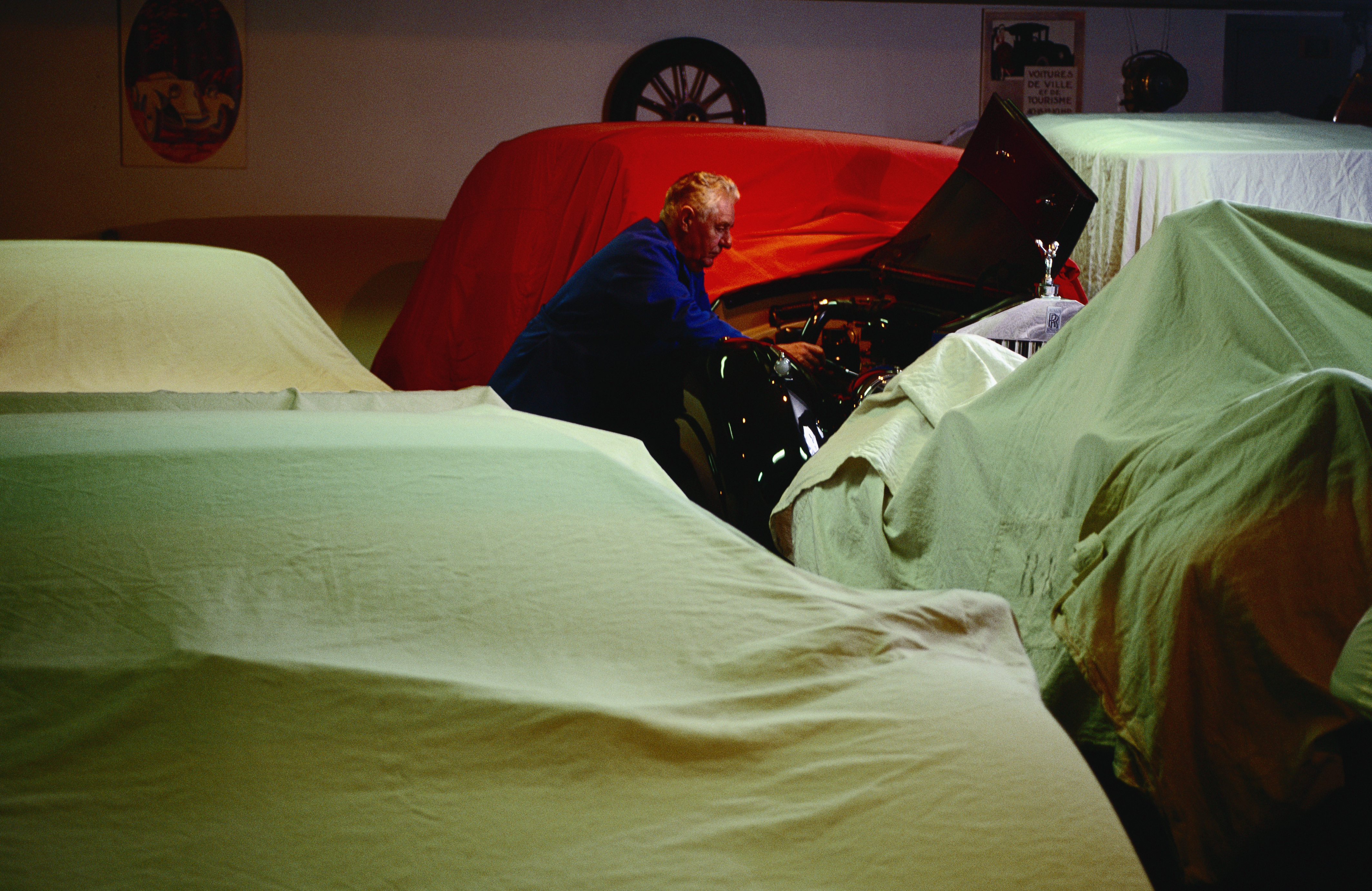 The chief auto mechanic of the royal family of Monaco cleans one of Prince Rainier III's 80 vintage automobiles.